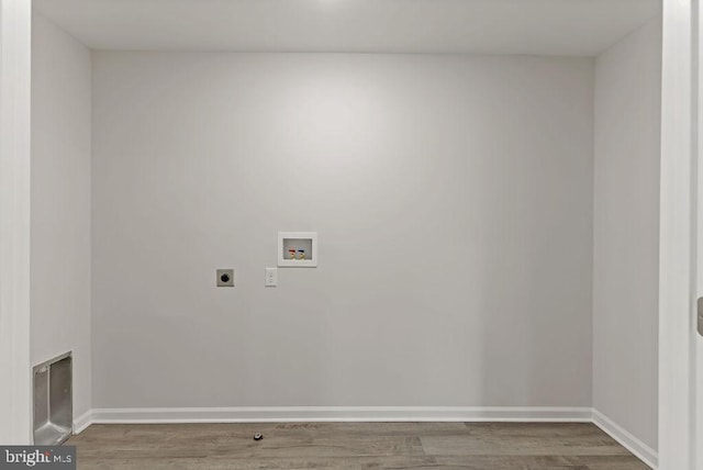 laundry room with electric dryer hookup, hardwood / wood-style floors, and washer hookup