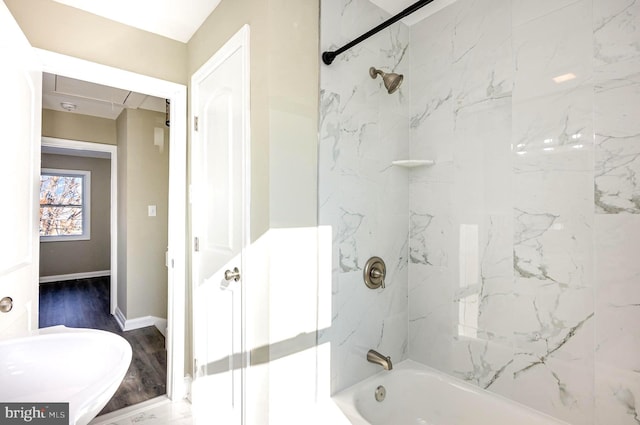 bathroom with wood-type flooring and tiled shower / bath combo