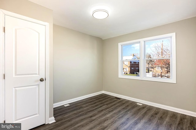 empty room with dark hardwood / wood-style floors