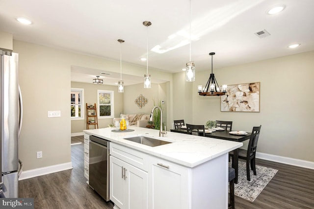 kitchen with white cabinetry, sink, stainless steel appliances, dark hardwood / wood-style flooring, and a kitchen island with sink