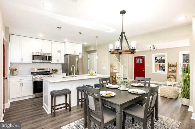 dining space with dark wood-type flooring and sink