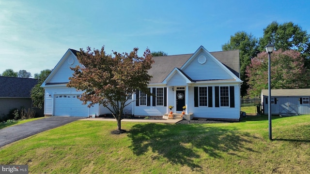 view of front of house with a garage and a front lawn