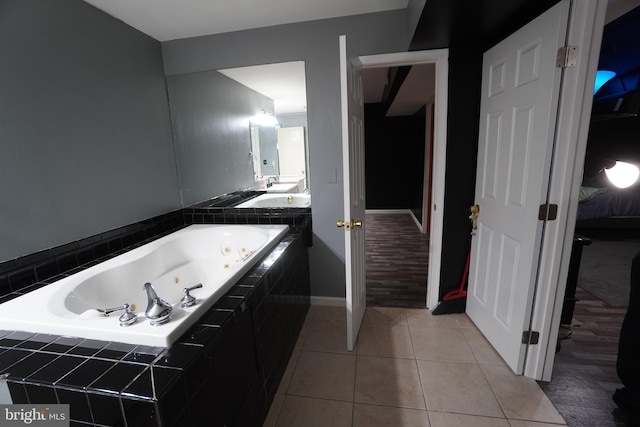 bathroom with tiled tub and tile patterned floors