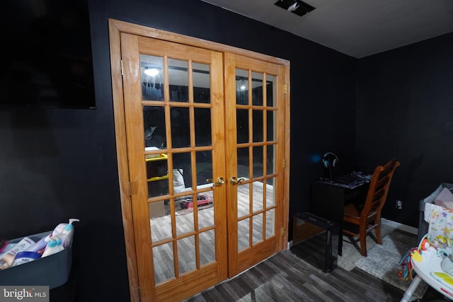 doorway to outside with dark wood-type flooring and french doors