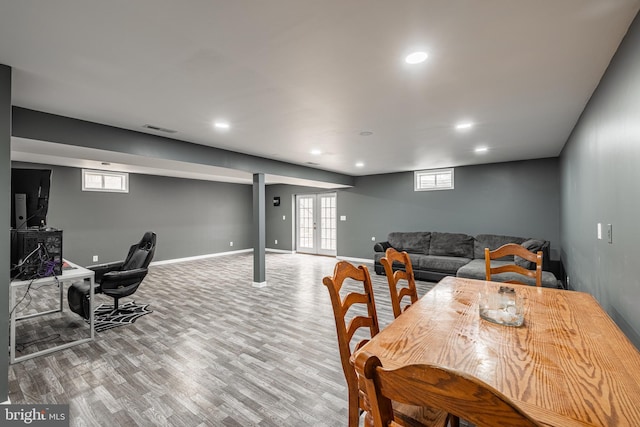 dining space featuring wood-type flooring and french doors