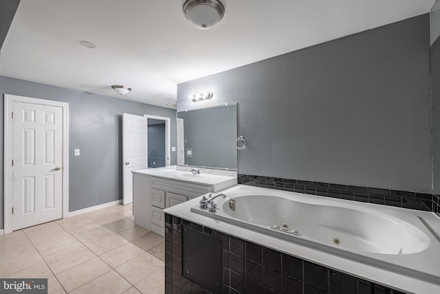 bathroom with vanity, tiled tub, and tile patterned floors