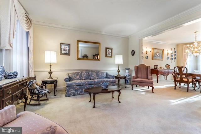 living room with light carpet, ornamental molding, and a notable chandelier