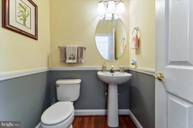 bathroom featuring hardwood / wood-style floors and toilet