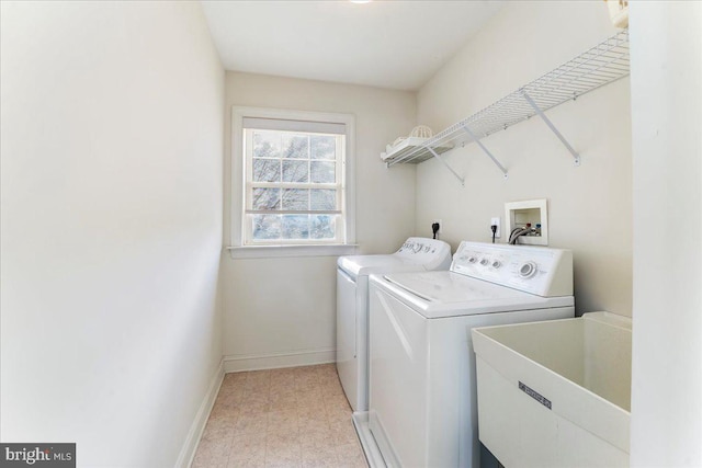 laundry area with independent washer and dryer and sink