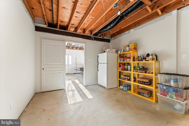 basement with white refrigerator