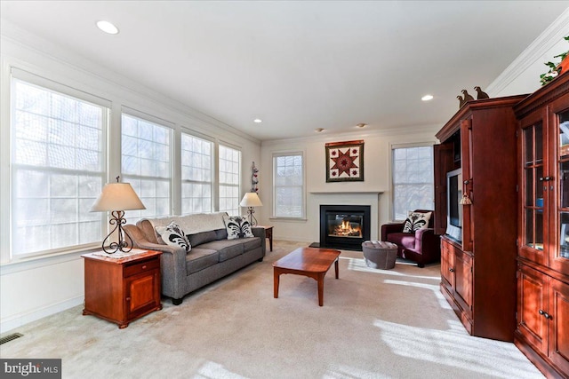 living room with ornamental molding and light carpet