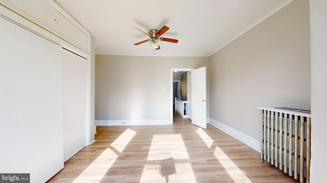 unfurnished bedroom with ceiling fan, a closet, and light hardwood / wood-style flooring