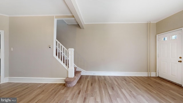 entrance foyer with ornamental molding and light wood-type flooring