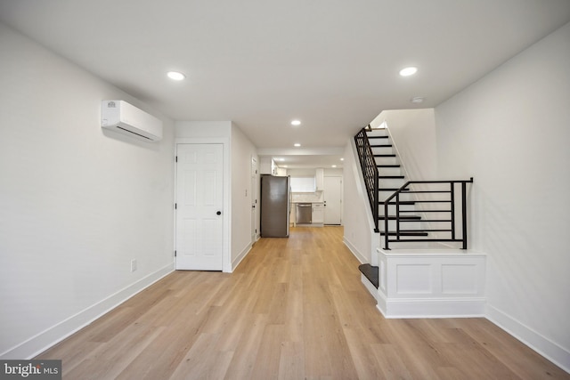 hall featuring an AC wall unit and light wood-type flooring