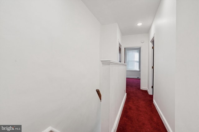 hallway with dark carpet