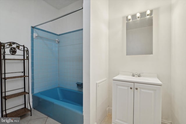 bathroom with tile patterned flooring, vanity, and tiled shower / bath combo