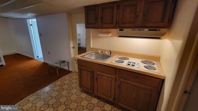 kitchen with white stovetop, sink, and exhaust hood