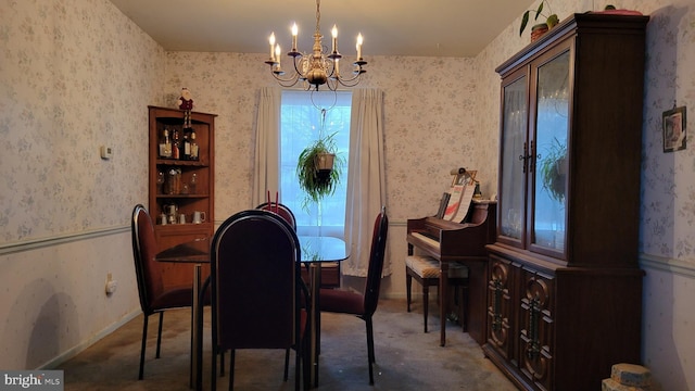 dining area with a chandelier and carpet floors