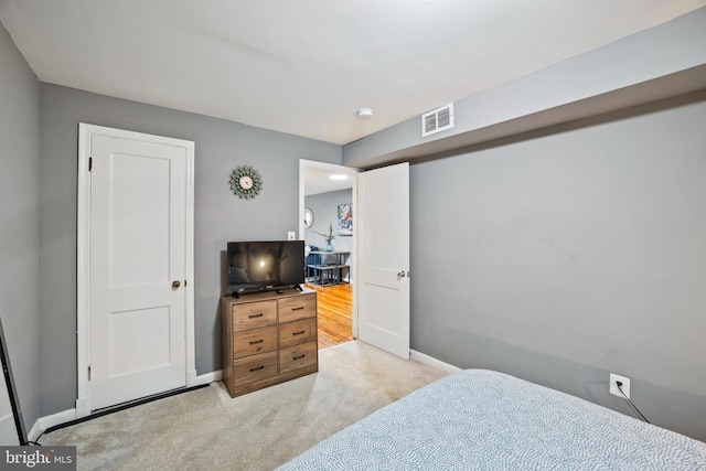 bedroom with light colored carpet