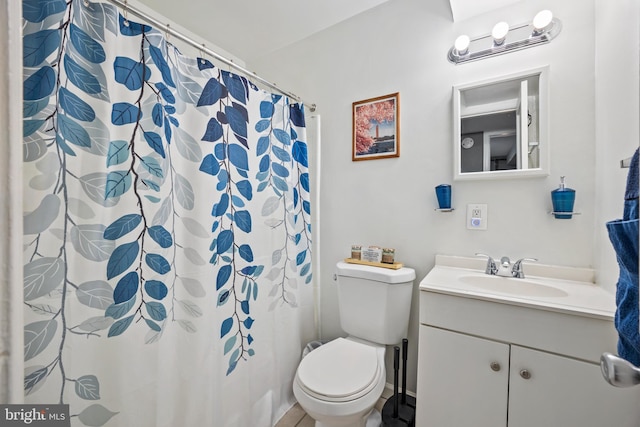 bathroom featuring vanity, a shower with shower curtain, and toilet