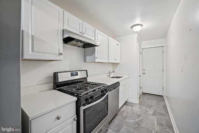 kitchen featuring stainless steel appliances, white cabinetry, and sink