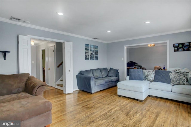 living room with light hardwood / wood-style flooring and ornamental molding