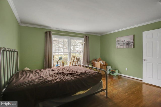 bedroom with wood-type flooring and ornamental molding