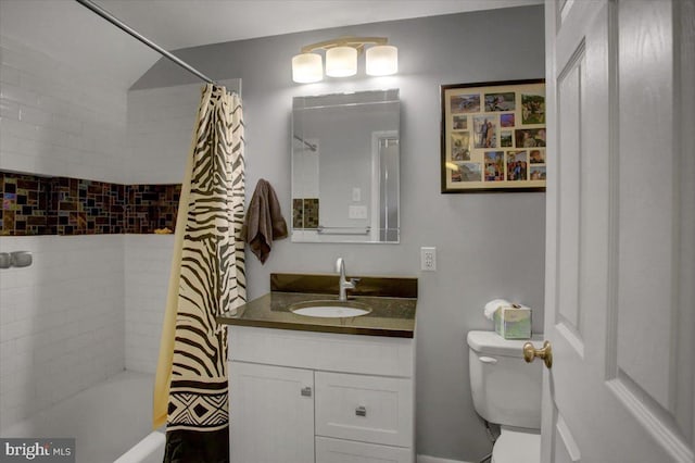 full bathroom featuring vanity, shower / bath combination with curtain, and toilet