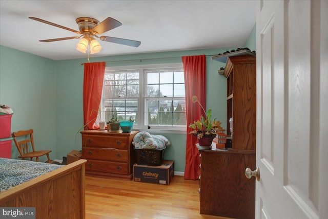 bedroom with ceiling fan and light hardwood / wood-style floors