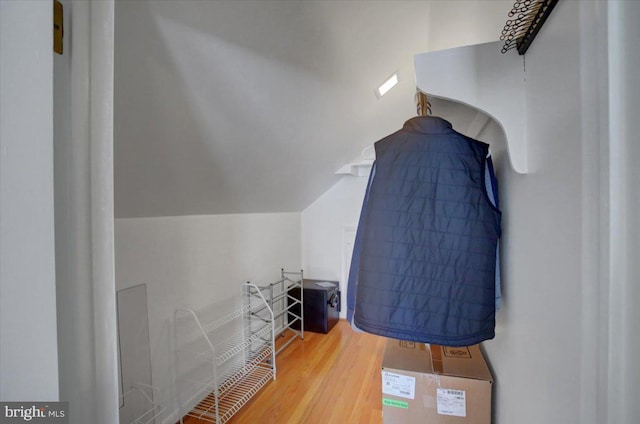 bedroom featuring hardwood / wood-style flooring and vaulted ceiling