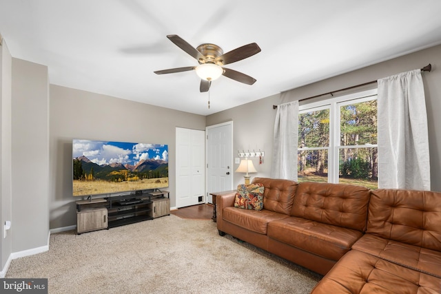 living room featuring carpet flooring and ceiling fan