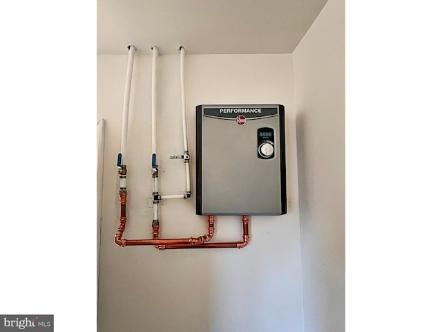 utility room featuring water heater