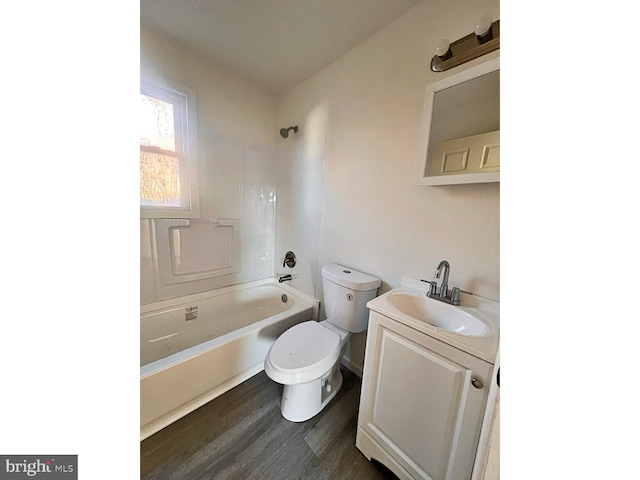 full bathroom featuring washtub / shower combination, hardwood / wood-style floors, vanity, and toilet