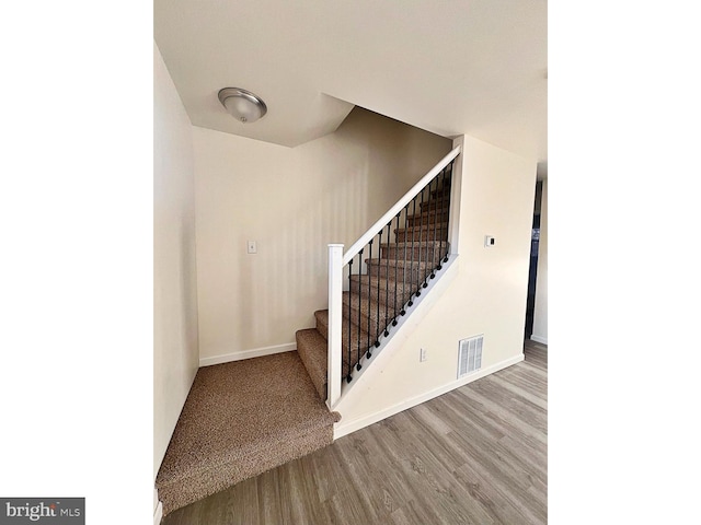 stairway with wood-type flooring