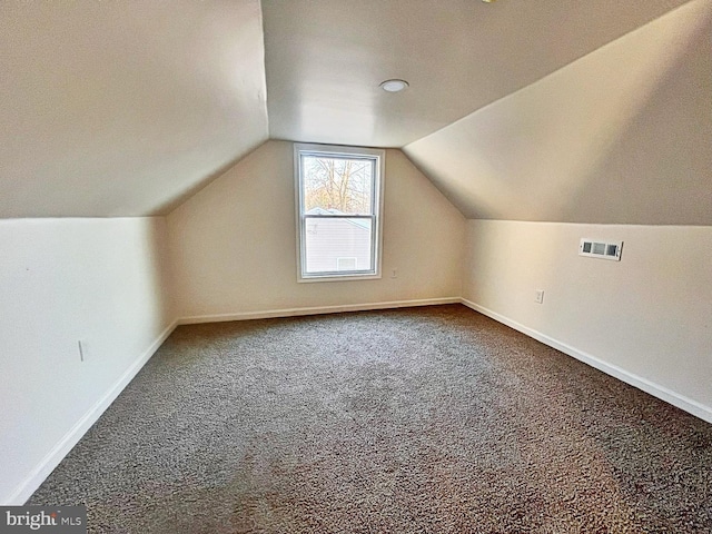 bonus room with a textured ceiling, carpet, and vaulted ceiling