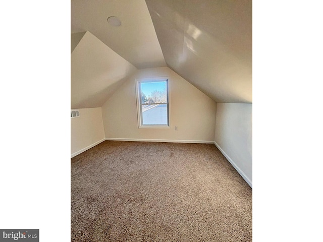 bonus room with carpet flooring and lofted ceiling