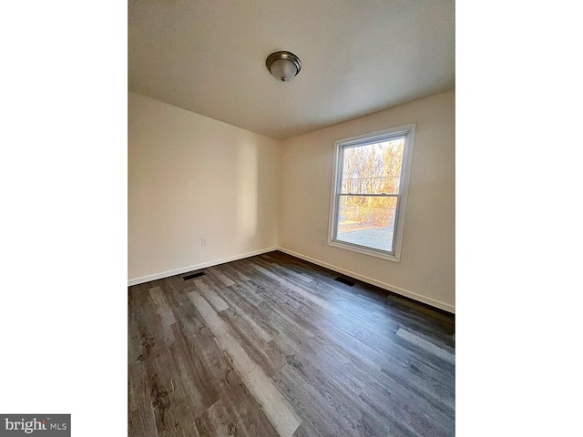 unfurnished room with hardwood / wood-style flooring