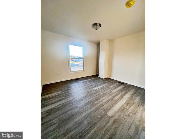 spare room featuring dark hardwood / wood-style floors