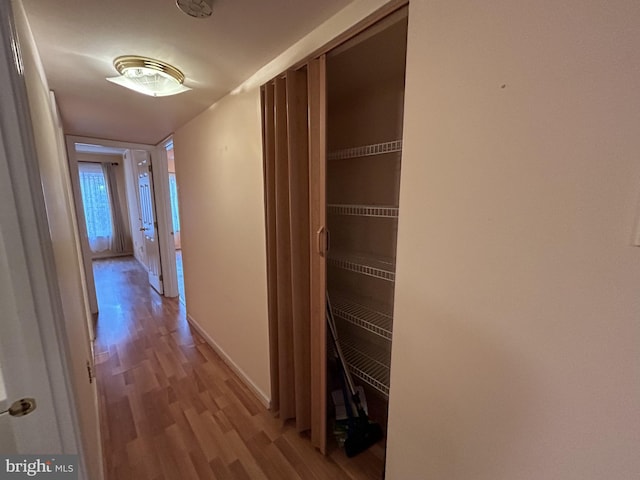 corridor with light hardwood / wood-style flooring