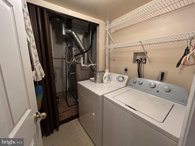 clothes washing area with washing machine and dryer