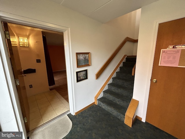 stairs featuring tile patterned floors