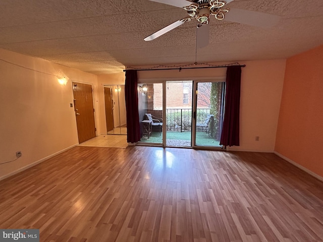 unfurnished room featuring hardwood / wood-style floors and ceiling fan