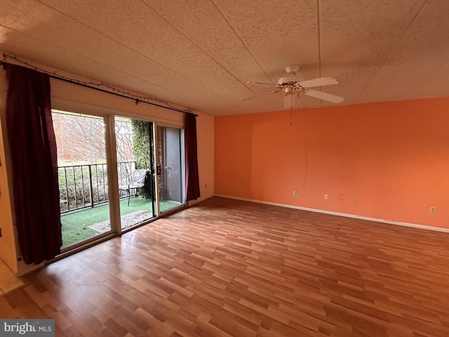 spare room with hardwood / wood-style floors and ceiling fan