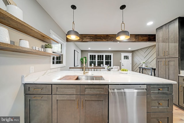 kitchen featuring stainless steel dishwasher, light hardwood / wood-style floors, light stone countertops, beam ceiling, and kitchen peninsula