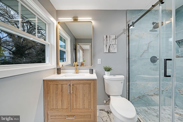 bathroom featuring vanity, toilet, and walk in shower