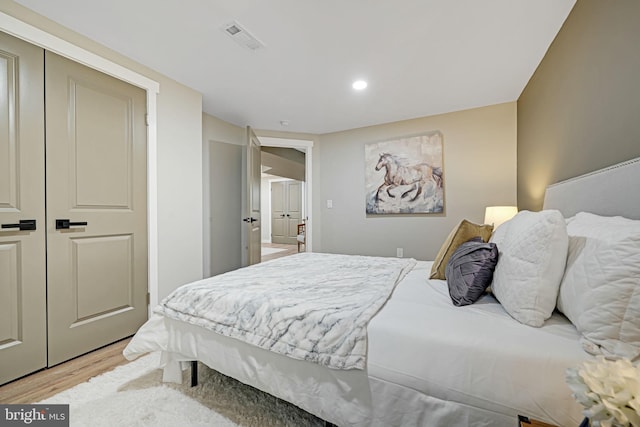 bedroom featuring a closet and light wood-type flooring