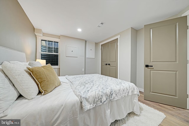 bedroom featuring light wood-type flooring and a closet