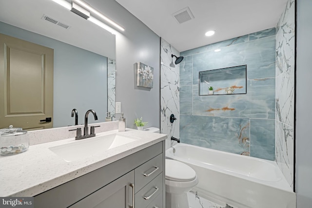 full bathroom featuring vanity, toilet, and tiled shower / bath