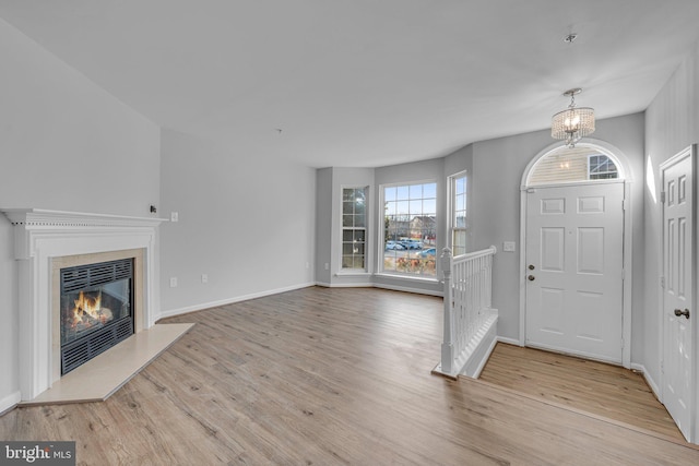 foyer featuring light hardwood / wood-style flooring and a notable chandelier