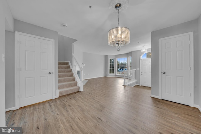 entrance foyer with a chandelier and light hardwood / wood-style flooring